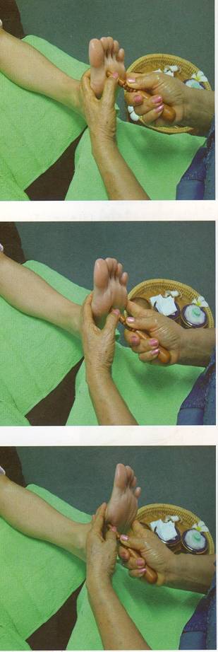 pregnant lady at Cardiff clinic getting reflexology with special wooden stick for IVF support